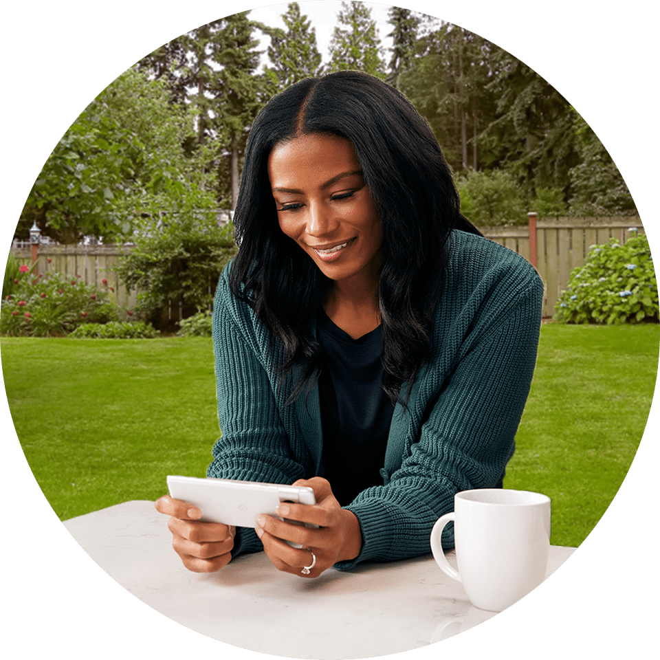 Woman in the backyard on the patio using Tablo on her phone