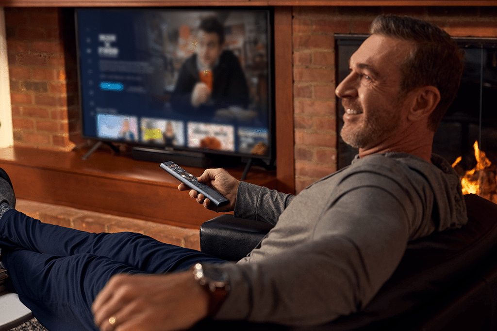 Man watching WB FAST channels on Tablo