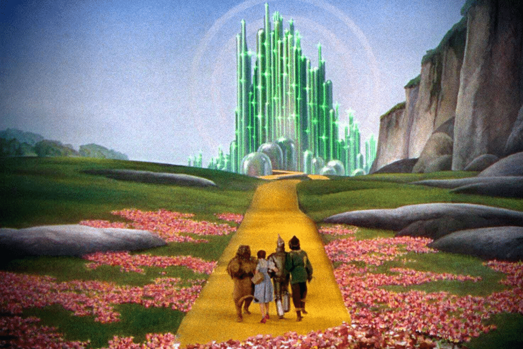 The Emerald city and Yello Brick Road. Dorthy, the Lion, Tinman and Scarecrow traveling towards it.